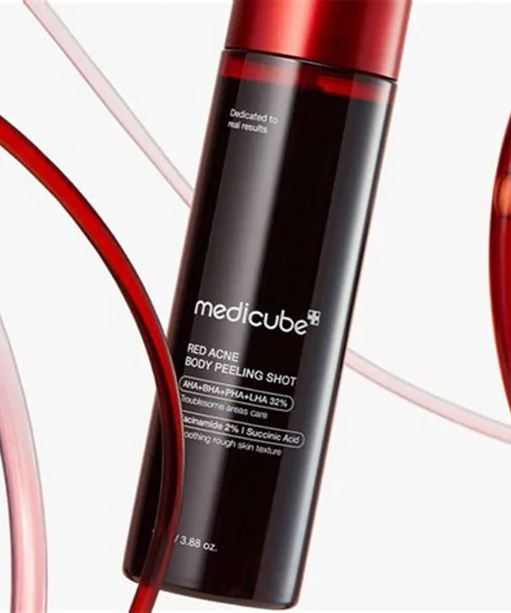 A high-contrast close-up of the Medicube Red Acne Body Peeling Shot in a dark bottle with a metallic red cap, framed by artistic, flowing red serum lines on a clean white background