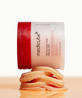 Medicube red rubber acid peeling pad with red lid on a beige background