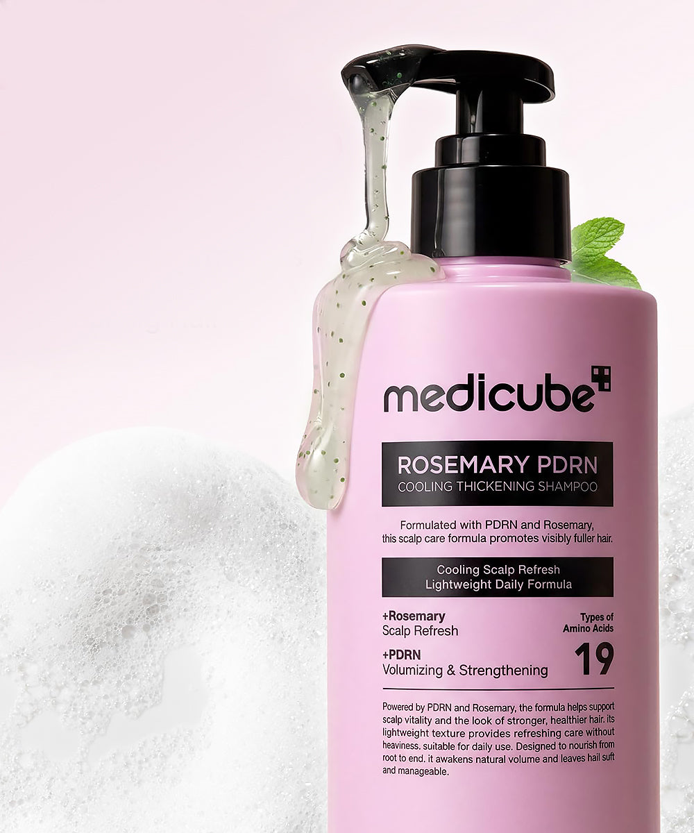 Pink shampoo bottle with pump labeled 'medicube' on a white background