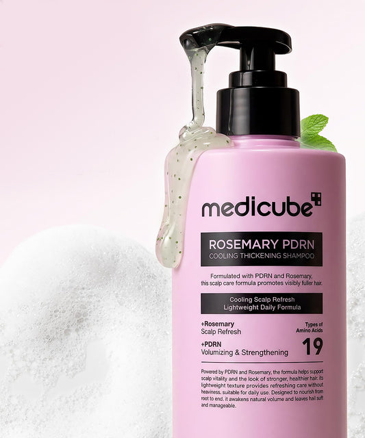 Pink shampoo bottle with pump labeled 'medicube' on a white background