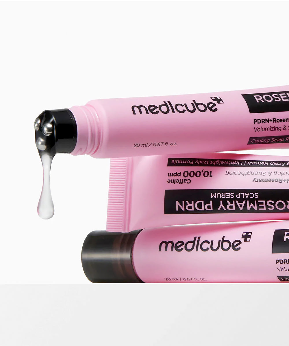 Pink Medicube serum bottle with dropper on a white background