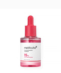 Medicube TXA Niacinamide 15 Serum bottle with pink cap on a white background