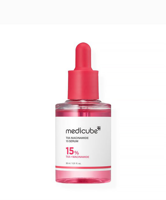 Medicube TXA Niacinamide 15 Serum bottle with pink cap on a white background