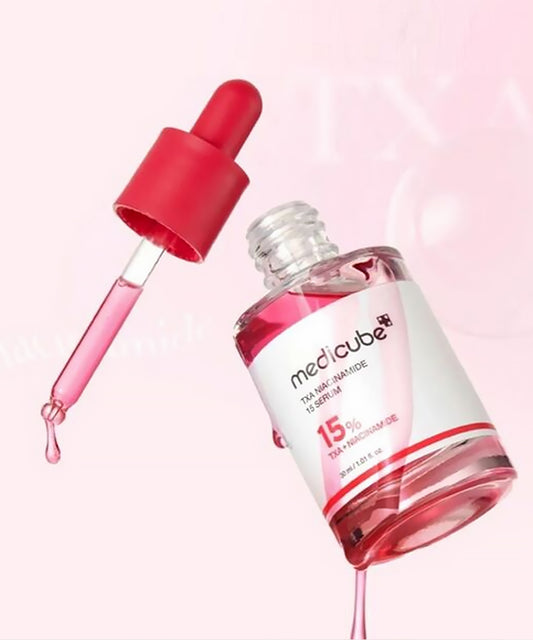 Medicube serum bottle with dropper on a pink background