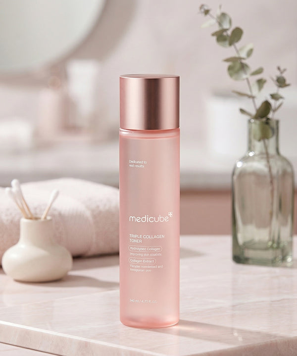 The toner bottle stands on a marble surface in a bright bathroom setting, accompanied by a small vase of eucalyptus and a white towel
