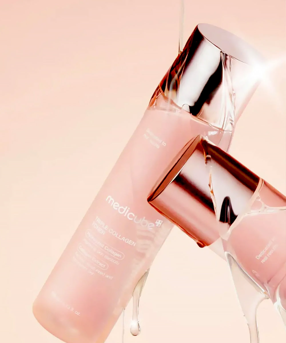 A dynamic, close-up shot of the toner bottle being splashed with clear liquid, featuring bright light glints on the metallic cap