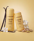 Two Medicube Fresh That Lasts moisturizer tubes in a warm yellow-beige tone, styled with vanilla beans, white flowers, and pistachios on a matching beige background.