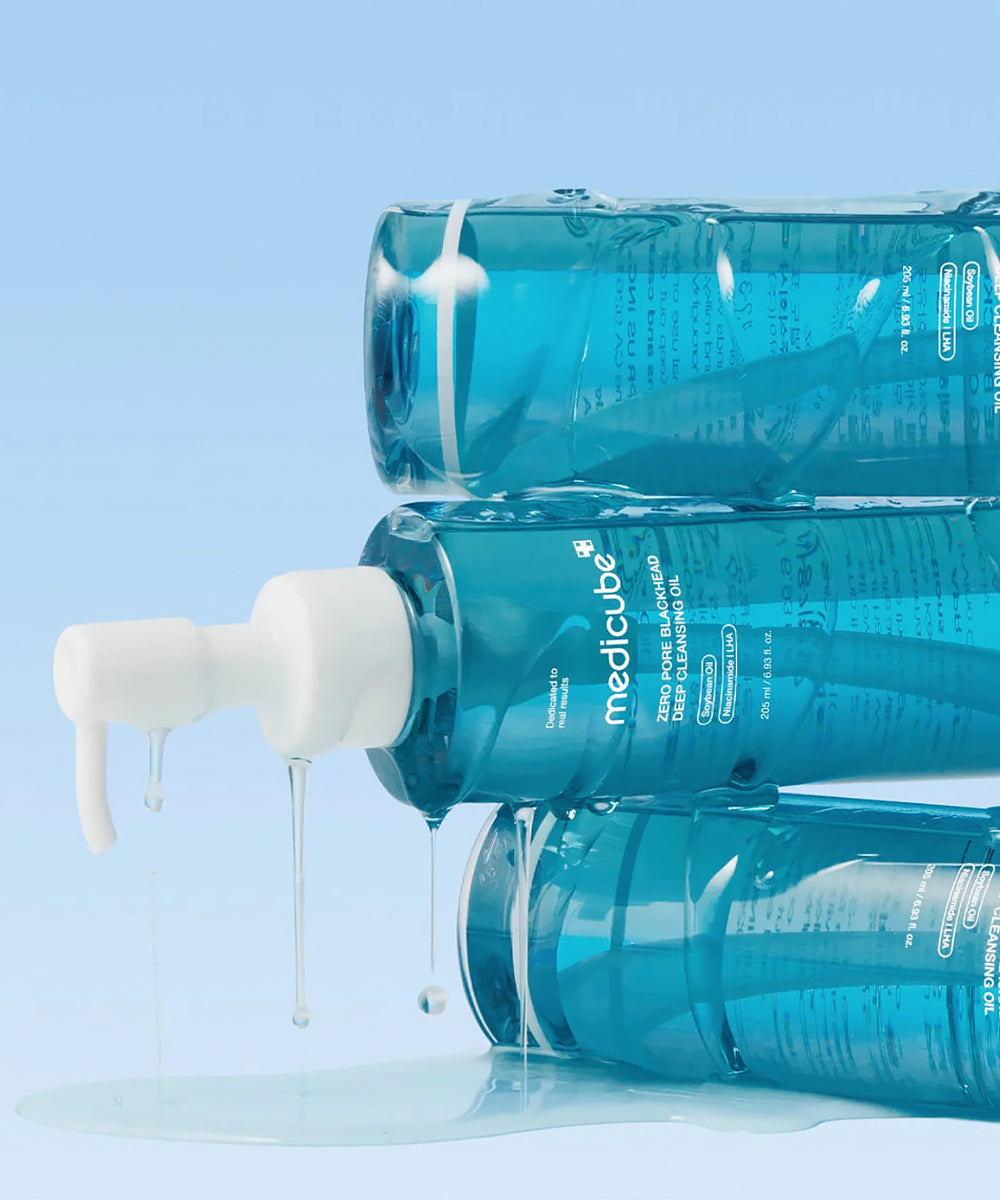Three blue bottles with white nozzles on a light blue background