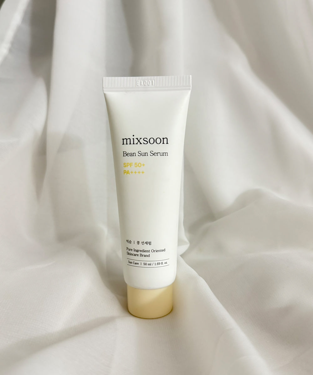 Tube of mixsoon Bean Sun Serum on a white fabric background