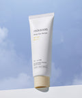 Tube of mixsoon Bean Sun Serum against a blue sky background
