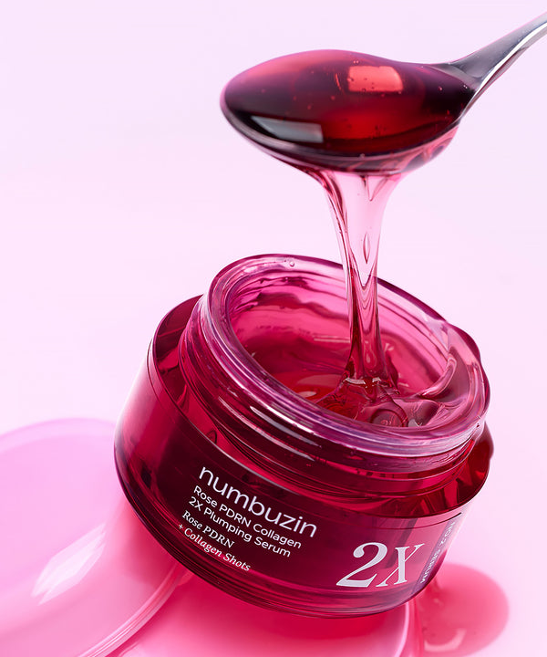 Close-up of the pump dispensing a drop of the light pink plumping serum, highlighting its silky, lightweight, and hydrating texture