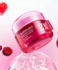 Macro texture shot of the glossy pink serum on a clean surface, emphasizing its concentrated, moisture-rich consistency for a "glass skin" finish.