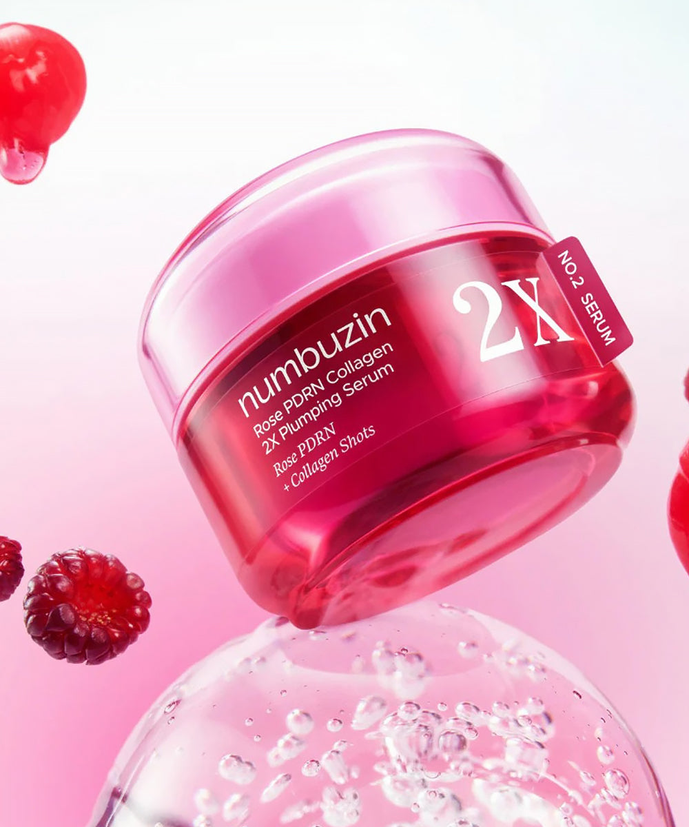 Macro texture shot of the glossy pink serum on a clean surface, emphasizing its concentrated, moisture-rich consistency for a "glass skin" finish.