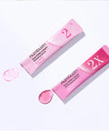 Close-up of the Numbuzin No.2 serum being dispensed, highlighting the silky, translucent pink liquid texture designed for deep hydration and skin elasticity