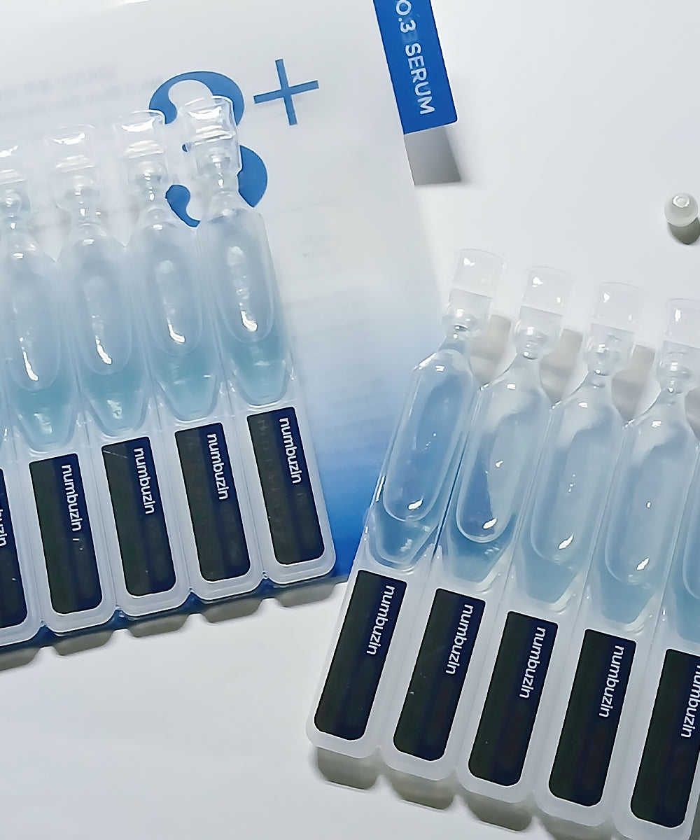 Detailed close-up of the Numbuzin No.3+ serum bottle, emphasizing the "Blue Bio-Retinol" label and the specialized formula intended for pore tightening and skin texture improvement