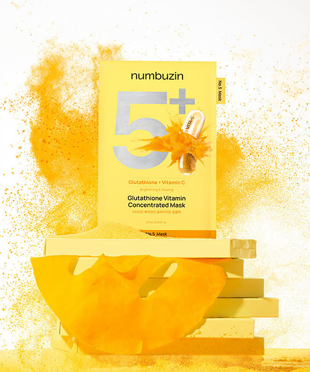 Close-up of the Numbuzin No.5 sheet mask being removed from the packaging, showcasing the yellow-tinted essence infused with concentrated glutathione and Vitamin C