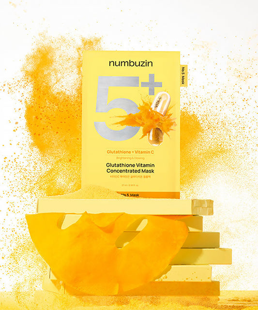 Close-up of the Numbuzin No.5 sheet mask being removed from the packaging, showcasing the yellow-tinted essence infused with concentrated glutathione and Vitamin C
