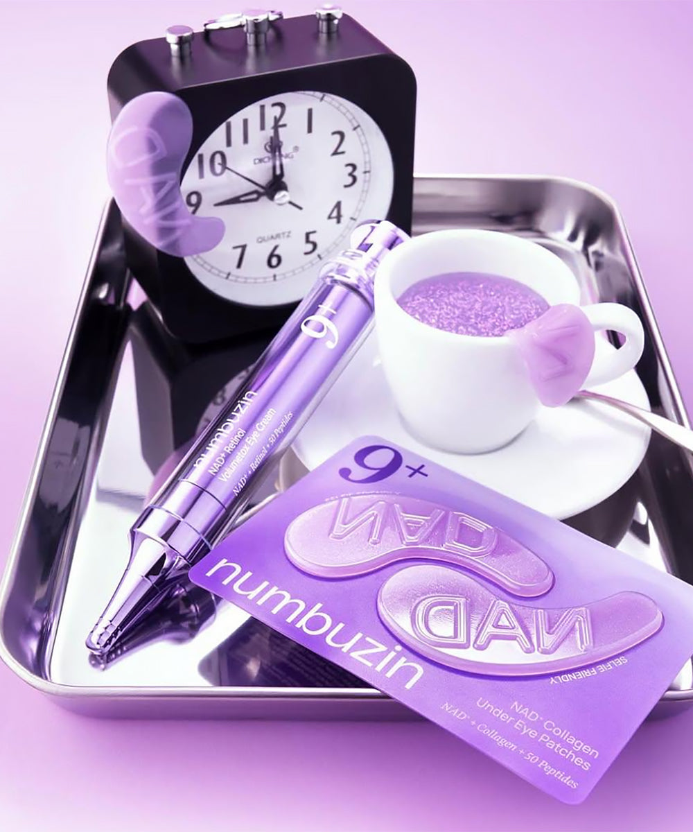 Purple items including a pen, eye patch, and clock on a tray with a purple background