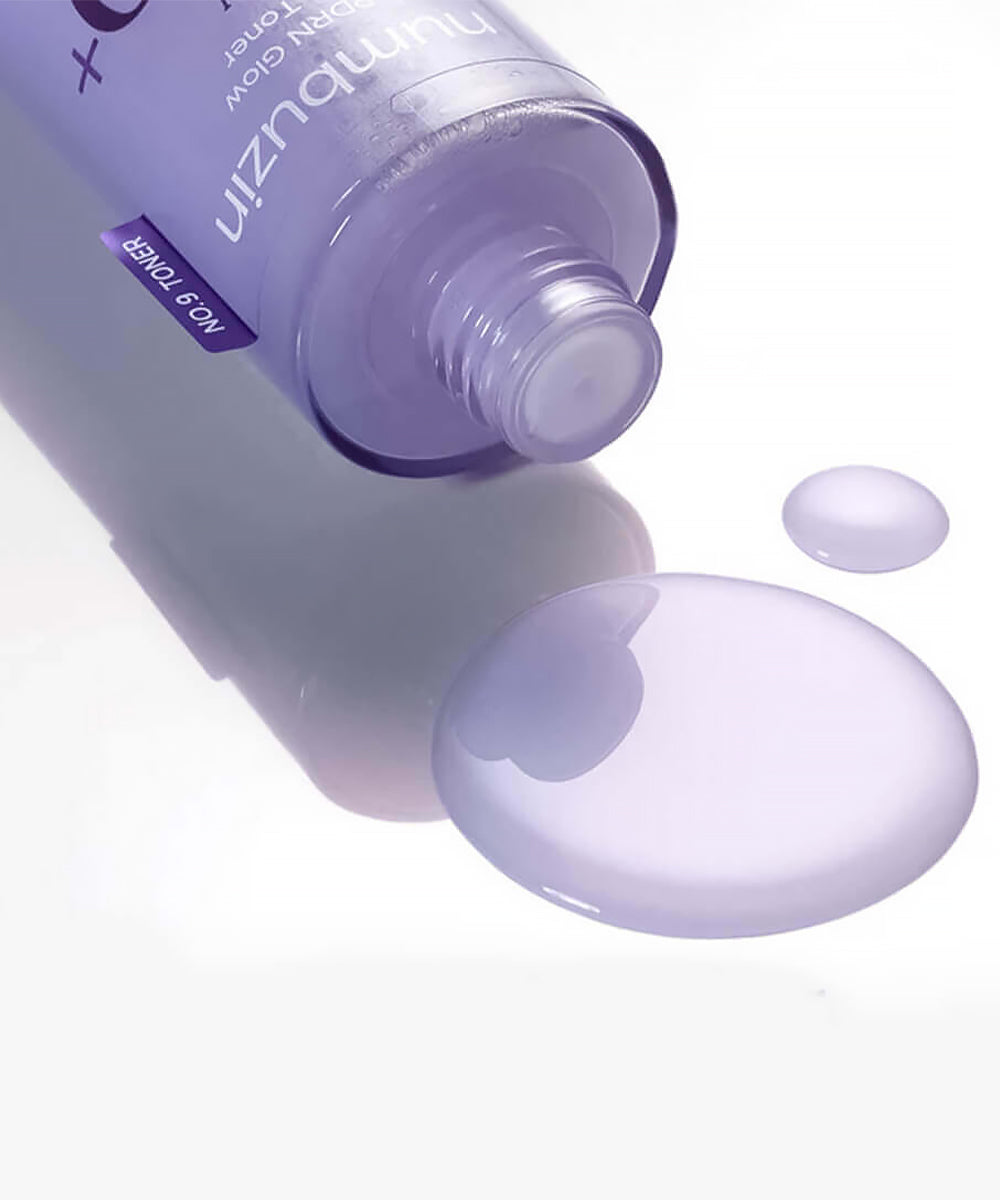 Purple skincare product with droplets on a white background