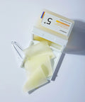Pack of facial wipes with a clear lid on a white background