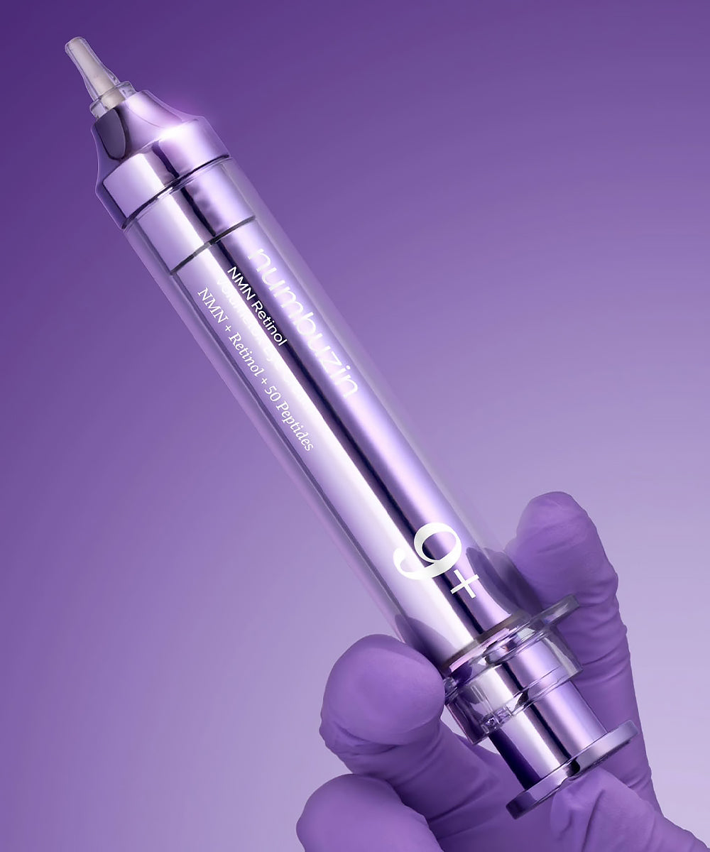 Purple medical device held by a gloved hand against a purple background