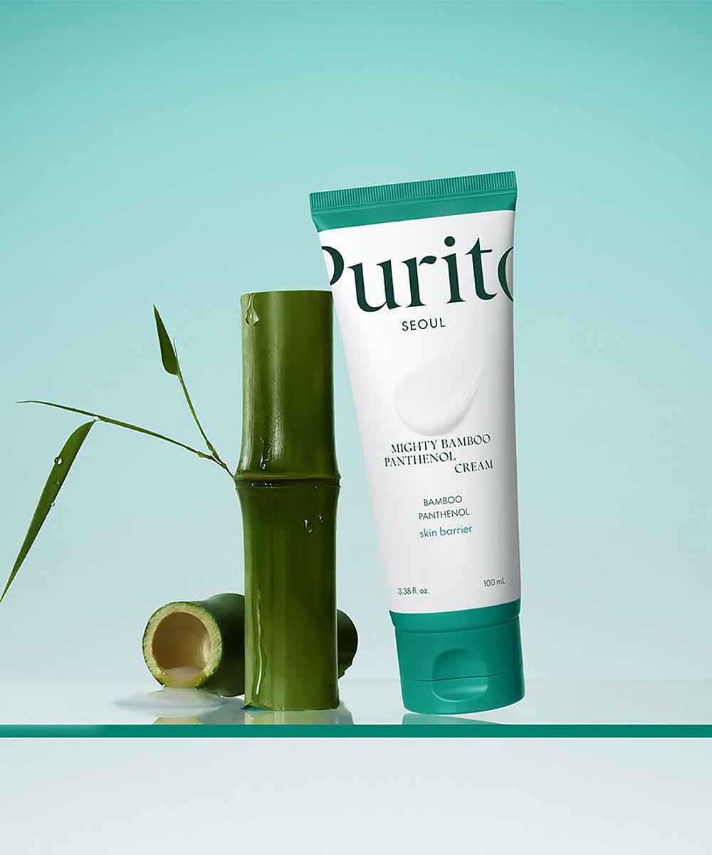 Tube of Purito Mighty Bamboo Panthenol Cream with bamboo pieces on a light blue background