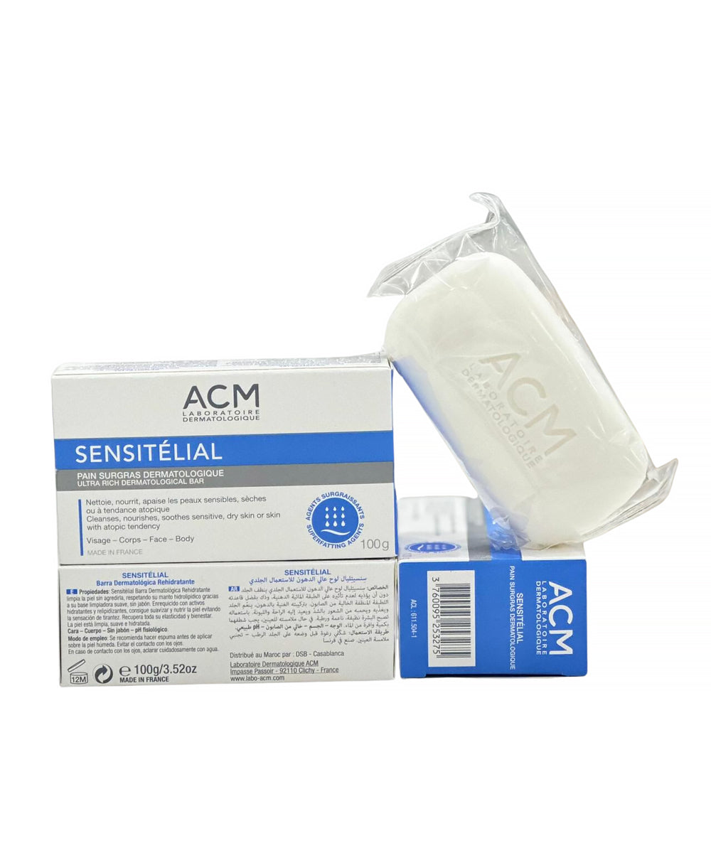 A comprehensive grouping of ACM SENSITÉLIAL products, including stacked boxes and an individually clear-wrapped soap bar, displaying all packaging components