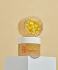 Skincare product with yellow capsules on a beige background