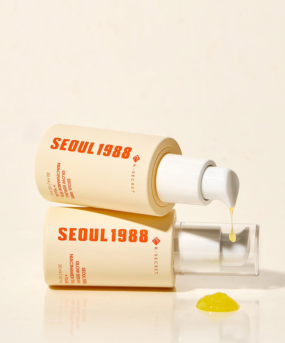 Two 'SEOUL 1988' skincare bottles with a dropper on a beige background