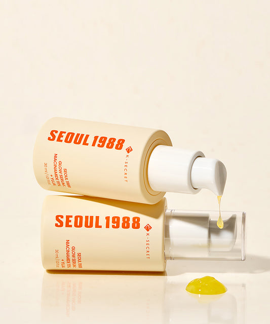 Two 'SEOUL 1988' skincare bottles with a dropper on a beige background