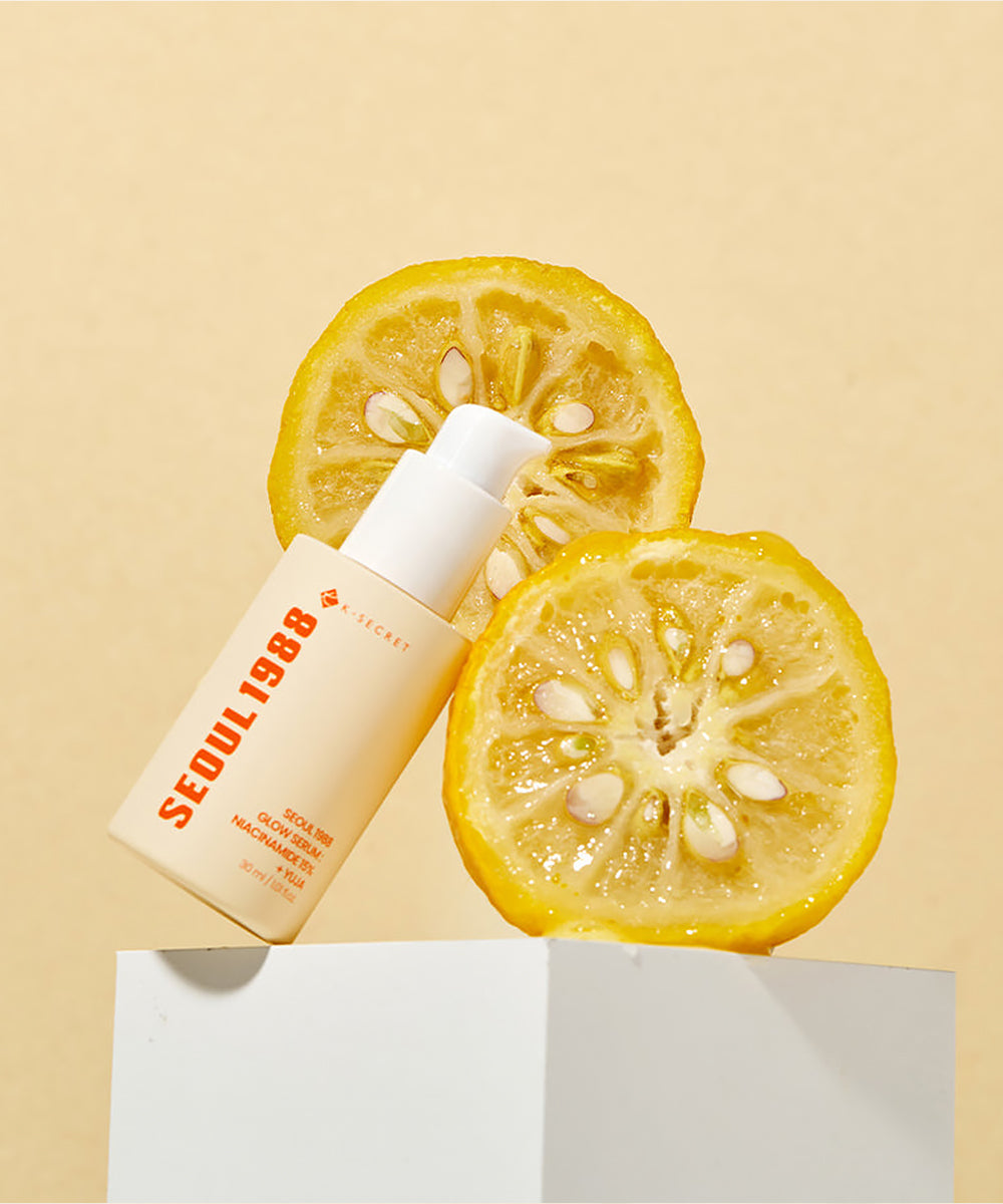 Skincare bottle labeled 'Seoul 1988' with sliced lemons on a beige background