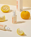 Skincare products with lemons on a light background