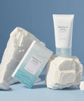 Skintifica Centella skincare products on a textured white surface with a blue background