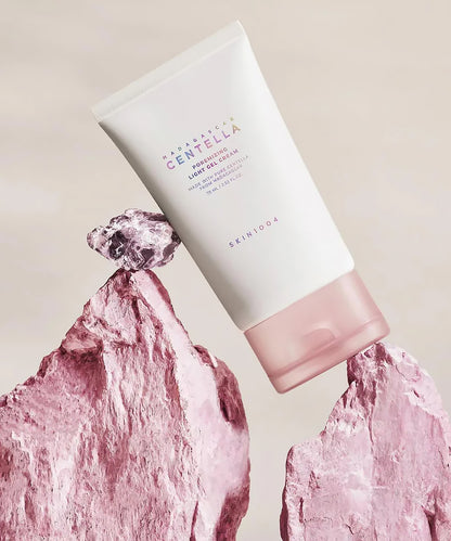 Skincare product with pink rock-like design on a beige background
