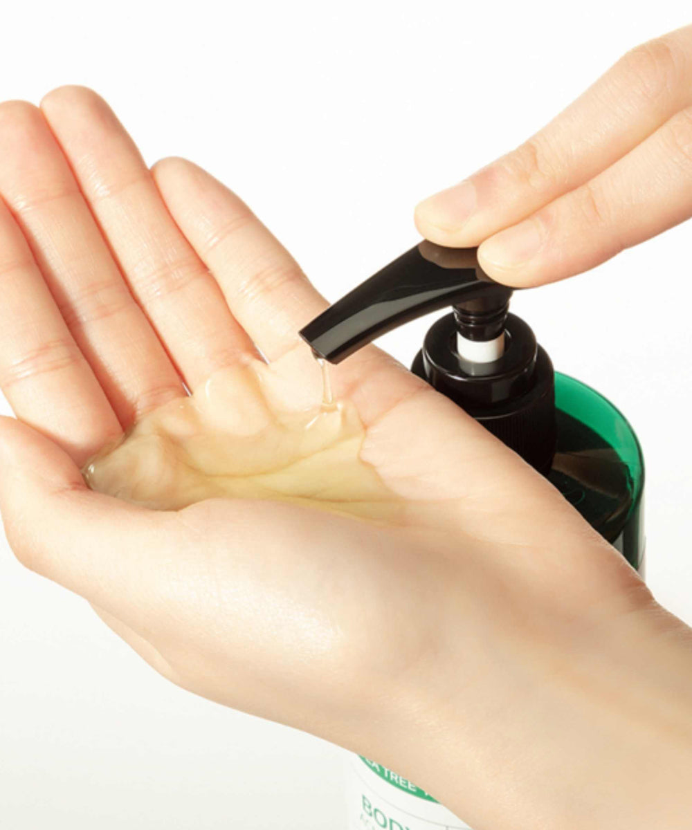 Hand using a pump bottle to dispense liquid soap onto another hand.