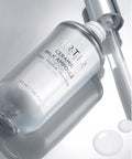 TIRTIR Ceramic Milk Ampoule bottle with dropper on a light gray background