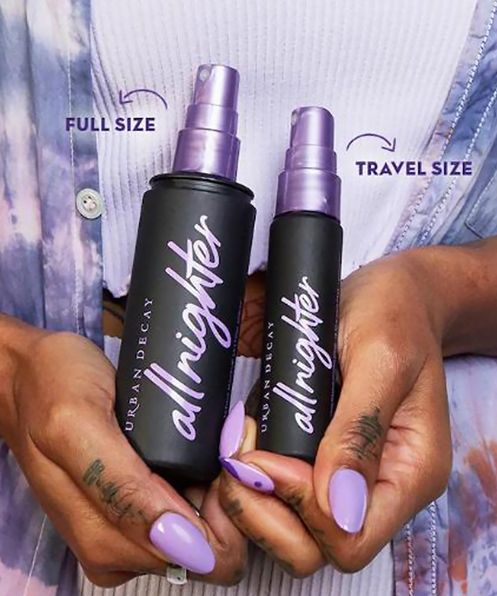 Two 'allrighter' spray bottles, one full size and one travel size, held by hands with purple nail polish.