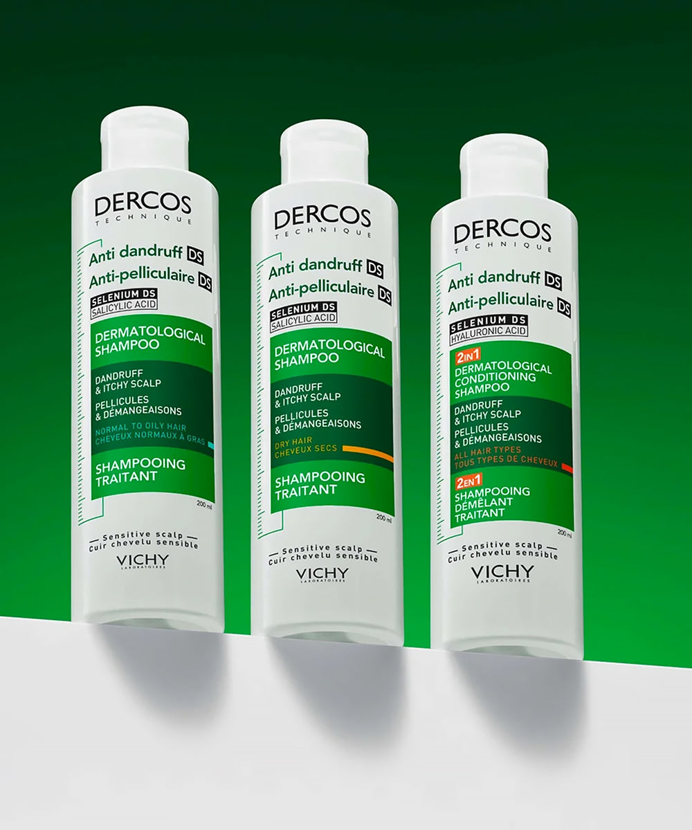 Three bottles of Vichy Dercos Anti-dandruff Shampoo on a green background