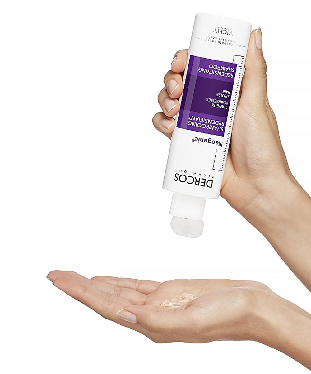 Hands dispensing clear gel from Vichy Dercos Neogenic Shampoo bottle into a palm